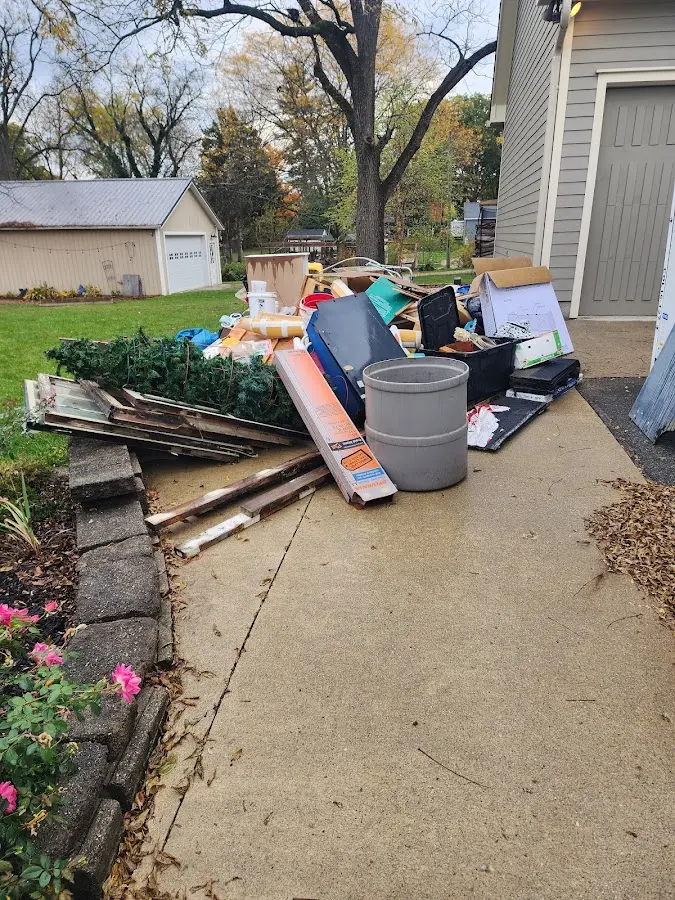 Dumpster being loaded with debris for Estate Cleanout Dumpster Rental in Piney